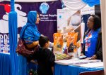 Woman and child interacting at a bakery expo.