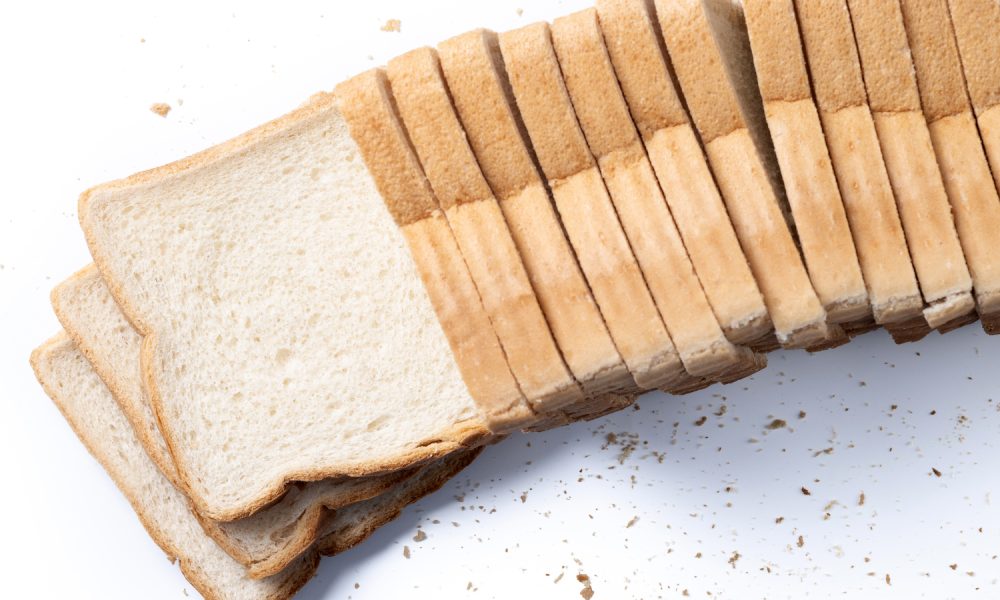 Sliced bread arranged in a neat row.