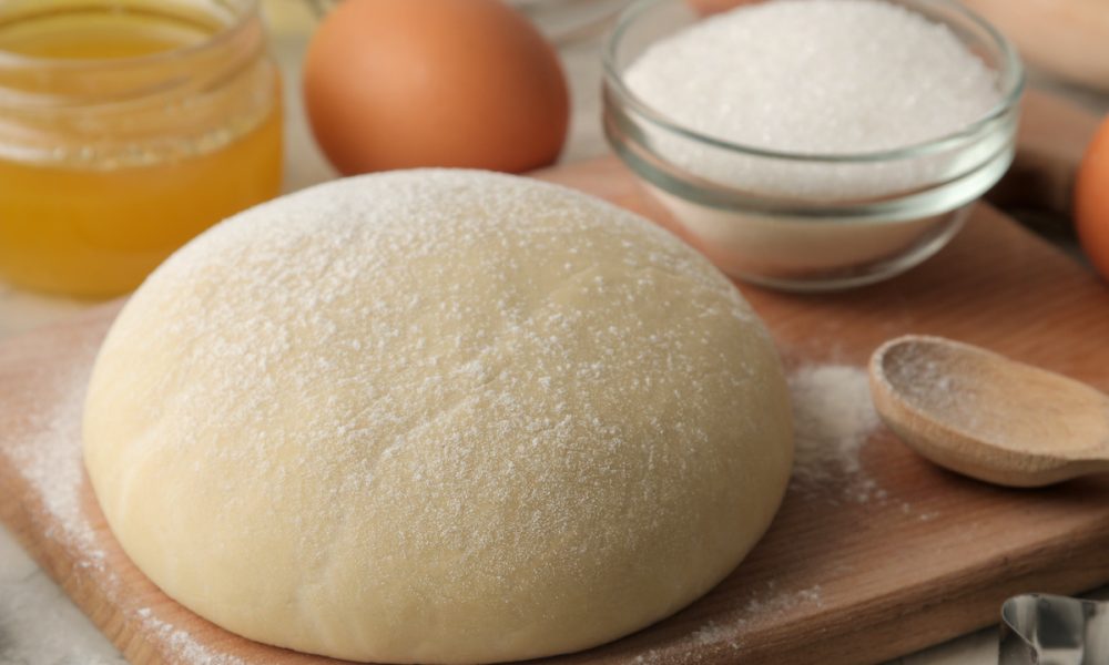 Baking ingredients with dough, sugar, and eggs.