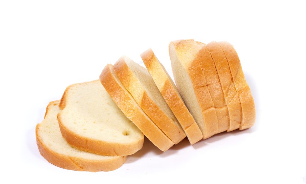 Slices of fresh bread arranged on a white background.