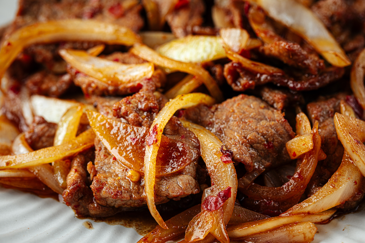 Sizzling beef and onions in savory sauce.