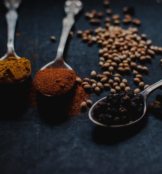 Assortment of essential herbs and spices used in the kitchen including turmeric and other aromatics