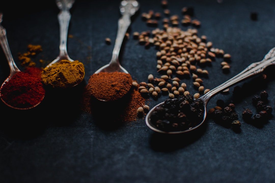 Assortment of essential herbs and spices used in the kitchen including turmeric and other aromatics