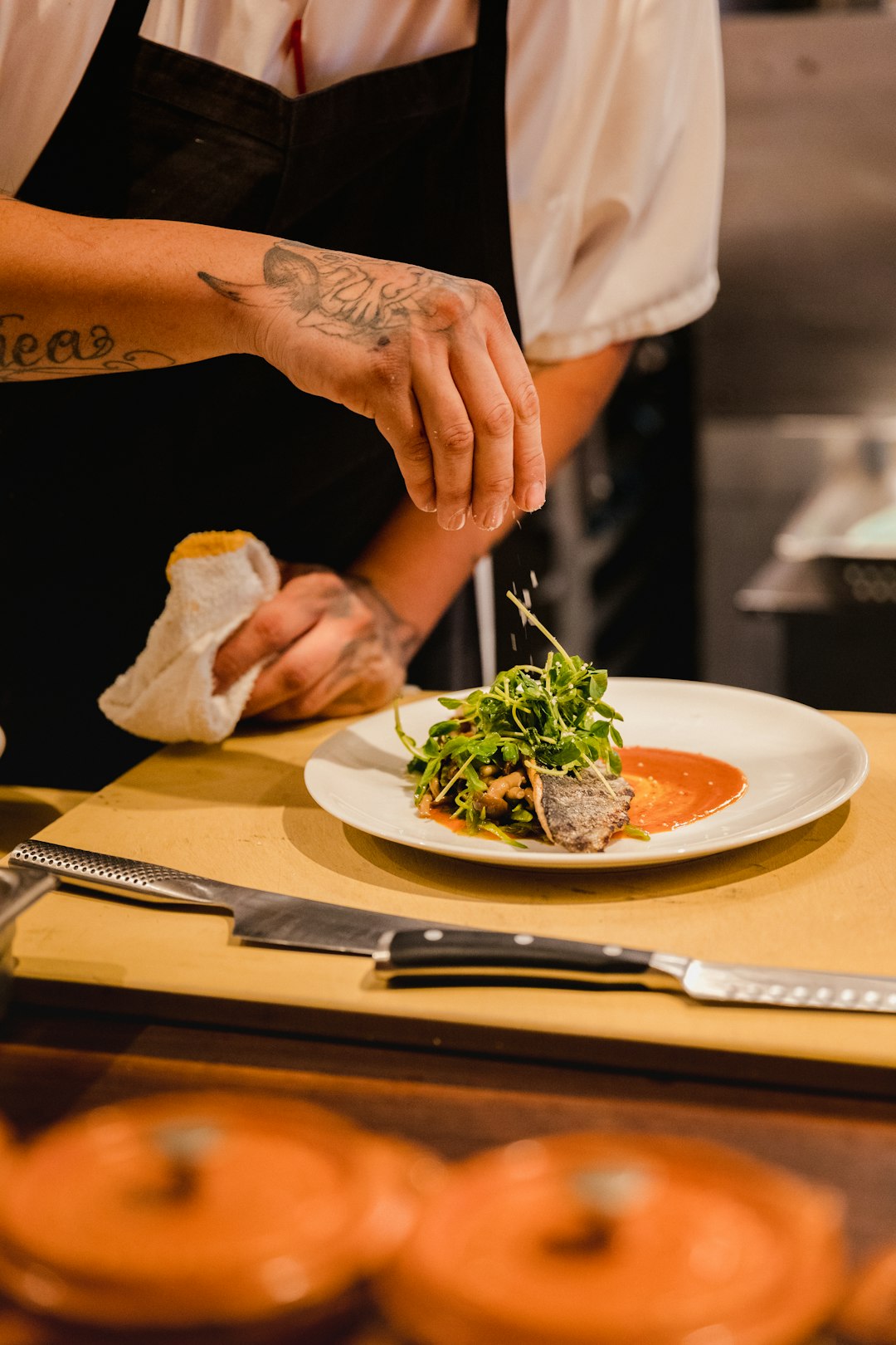 Chef standing in front of a plate with vegetables - restaurant food costing and profitability
